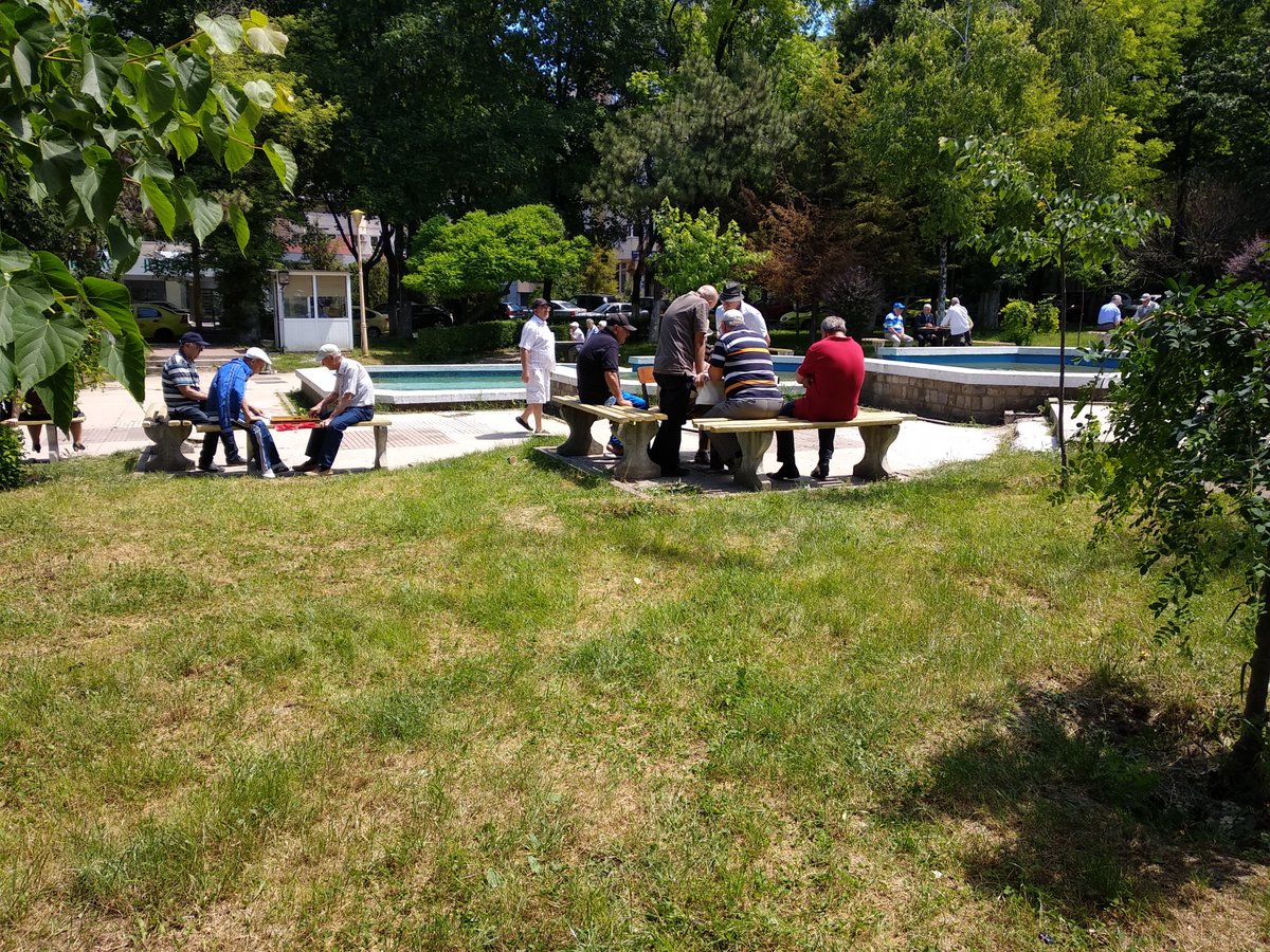 Elders playing board game on a park
